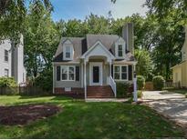 Charming two-story home with landscaped yard and inviting front porch, perfect for relaxing at 4916 Royal Adelaide Way, Raleigh, NC 27604