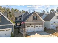Charming two-story home features a two-car garage, neat landscaping, and welcoming front porch at 74 Spruce Hollow Cir, Spring Lake, NC 28390