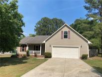 Charming single-Gathering home with a well-maintained lawn and attached two-car garage at 109 Rock Harbor Ln, Spring Lake, NC 28390