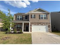 Charming two-story home featuring stone accents, a well-manicured lawn, and an attached two-car garage at 158 David Hill Dr, Sanford, NC 27330