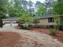Charming ranch-style home featuring an attached two-car garage and a well-manicured front yard with mature trees at 179A Fairway Ln, Sanford, NC 27332