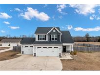 Charming two-story home featuring a three-car garage and classic architectural details, providing ample space at 1968 Josey Williams Road, Erwin, NC 28339