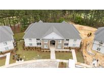 Spacious apartment building featuring a neutral color palette and well-manicured landscaping at 240 Gallery Dr # 203, Spring Lake, NC 28390