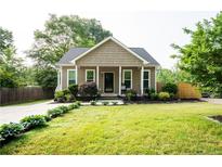 Charming single-Gathering home with a well-manicured lawn and inviting front porch at 303 Tanglewood Dr, Louisburg, NC 27549