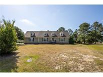 Charming single-Gathering home with dormer windows and a well-maintained front yard in a serene neighborhood at 390 Sandy Ridge Rd, Dunn, NC 28334