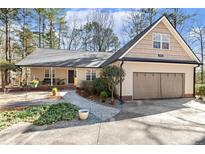Charming single-story home featuring well-manicured landscaping, attached garage, and inviting front porch at 5171 A Meadowlark Trl, Sanford, NC 27332