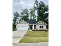 Charming single-story home with a two-car garage and manicured lawn at 55 Capeside Ct, Lillington, NC 27546