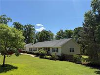 Charming single-story home with a well-manicured lawn and beautiful landscaping at 921 Pickard Rd, Sanford, NC 27330