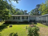 Charming single-story home with a manicured lawn and a welcoming front porch at 1017 Bailes Dr, Sanford, NC 27330