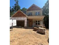 Charming two-story home featuring a stylish mix of materials and large windows, offering a welcoming facade at 188 Landon Rdg, Sanford, NC 27330