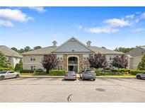 Well-maintained two-story residential building with parking, mature landscaping, and inviting architecture at 310 Gallery Dr # 201, Spring Lake, NC 28390
