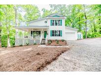 Charming two-story home with a welcoming front porch and manicured landscaping at 3224 Green Valley Dr, Sanford, NC 27330