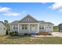 Charming single-story home featuring a well-manicured lawn, covered porch, and attached one car garage at 446 Placid Pond Dr, Broadway, NC 27505