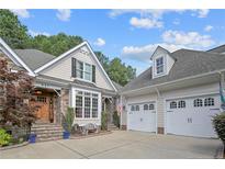 Beautiful home with a manicured lawn, stone accents, a welcoming front porch, and a two-car garage at 631 Anderson Creek Dr, Spring Lake, NC 28390