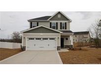 Charming two-story home featuring a spacious two-car garage and a well-maintained front lawn at 116 Artillery Ln, Cameron, NC 28326