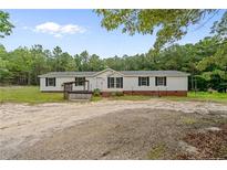 Charming single-story home with a welcoming front porch and well-maintained lawn at 171 Waters Way, Lillington, NC 27546