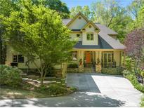 Charming home with covered porch, stone accents, inviting curb appeal, and a well-manicured front yard at 20017 Bragg, Chapel Hill, NC 27517