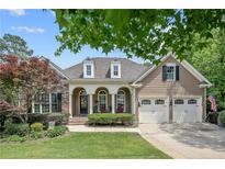 Charming single-Gathering home featuring a manicured lawn, stone accents, and an attached two-car garage at 42 Skipping Water Dr, Spring Lake, NC 28390