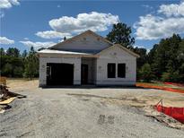 Under-construction home featuring the frame and initial layers of the building process at 60 Blossom Trl, Lillington, NC 27546