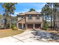 Charming two-story home featuring a stone facade, two-car garage, and well-maintained landscaping at 76 Slate Dr, Spring Lake, NC 28390