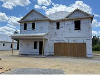 Unfinished two-story home showing the structure and basic layout with a covered porch in a construction phase at 78 Blossom Trl, Lillington, NC 27546