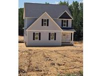 Charming two-story home featuring gray siding, black shutters, and a newly installed roof, ready for landscaping at 206 Uwharrie Way, Sanford, NC 27330