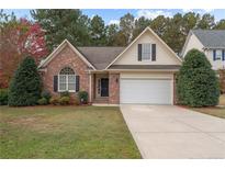 Charming one-story brick home featuring a two-car garage and well-manicured front lawn at 35 Shining Water Ln, Spring Lake, NC 28390