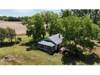 Quaint single-story home with a screened porch, wooden deck, metal roof and verdant lawn at 3997 Swanns Station Rd, Sanford, NC 27332