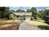 Charming single-story home with a well-manicured lawn and a paved driveway, featuring an attached garage at 73 Night Heron Ct, Sanford, NC 27332