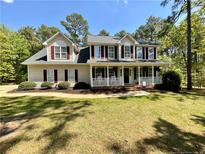 Charming two-story home with a welcoming front porch and well-manicured lawn at 259 Sandpiper Dr, Sanford, NC 27332