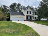Charming two-story home with a spacious two-car garage and well-maintained lawn at 284 Coachman Way, Sanford, NC 27332