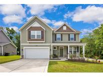 Charming two-story home with a covered front porch and well-manicured lawn at 296 Birch Ave, Spring Lake, NC 28390
