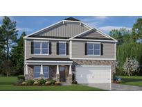 Two-story home boasts stone accents, gray siding, a two-car garage, and well-maintained landscaping at 668 Wilder Bloom Path, Aberdeen, NC 27526