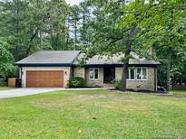 Charming single-story home featuring a large garage and a beautifully landscaped front yard at 75 Port Tack, Sanford, NC 27332