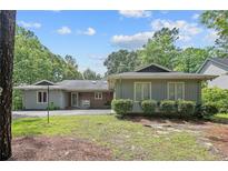 Ranch-style home with a well-maintained lawn and mature trees showcasing its inviting curb appeal at 95 Fairway Ln, Sanford, NC 27332