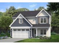 Charming two-story home boasts stylish curb appeal with a two-car garage and manicured lawn at 171 Travelers Way, Lillington, NC 27546