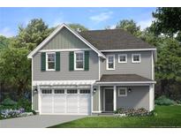 Charming two-story home with a two-car garage, well-manicured lawn, and beautiful landscaping at 178 Travelers Way, Lillington, NC 27546