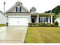 Charming home with a two-car garage, well-manicured lawn and inviting curb appeal at 4939 Pioneer Dr, Sanford, NC 27330