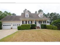 Charming one-story home with a two-car garage, dormer windows, and manicured landscaping at 70 Ramsey Ct, Cameron, NC 28326