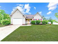Charming single-story home featuring a well-manicured lawn and a welcoming yellow front door at 2068 Tingen Rd, Broadway, NC 27505