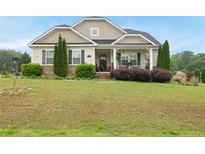 Charming single Gathering home with inviting front porch and lush green lawn at 2817 Oxford Bluff Dr, Wake Forest, NC 27587