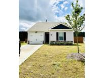 Charming single-story home featuring a gray facade, landscaped front yard and a driveway at 3202 Finch Ct, Sanford, NC 27332