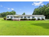 Charming single-story home with a well-maintained lawn, quaint porch, and symmetrical window placement at 99 Allen Brown Ln, Erwin, NC 28339