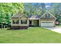 Charming single-story home features a well-manicured lawn and attached two-car garage at 1536 Louisiana Ln, Sanford, NC 27332