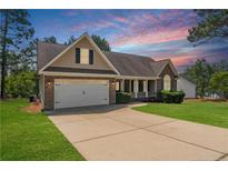 Charming single-Gathering home with a two-car garage and a well-manicured lawn at sunset at 16 Quail Holw, Sanford, NC 27332
