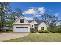 Charming two-story home with a well-manicured lawn and attached two-car garage at 24 Forest Hills Ct, Sanford, NC 27332