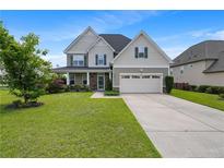 Charming two-story home with stone accents, a covered porch, and a well-maintained lawn at 415 Highgrove Highgrove Dr, Spring Lake, NC 28390