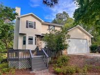 Charming home with a two car garage, gray deck, and well-maintained landscaping at 70 Oregon Ln, Spring Lake, NC 28390