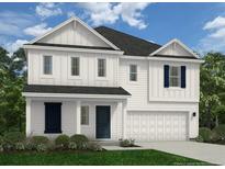 Two-story home boasts white siding, dark shutters, a two-car garage, and a well-manicured lawn at 88 Bennington Way, Lillington, NC 27546
