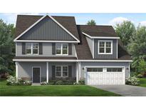 Charming two-story home with gray siding, stone accents, and a well-manicured lawn at 225 Persimmon Tree Dr, Cameron, NC 28326